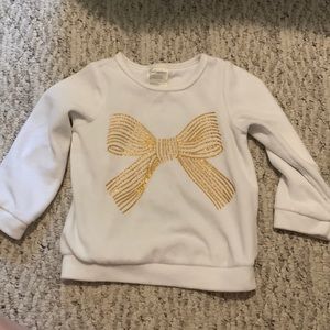 White sweatshirt with gold bow detail